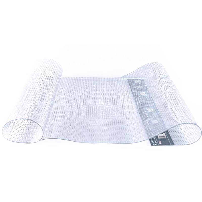 Rouleau de film LED transparent présenté à plat, connecteur visible sur la tranche